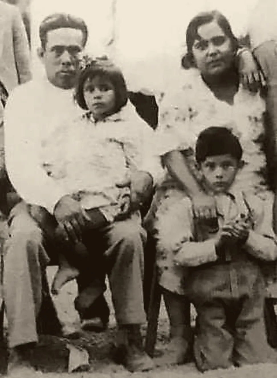Sepia archive photograph of a family group, 1930.